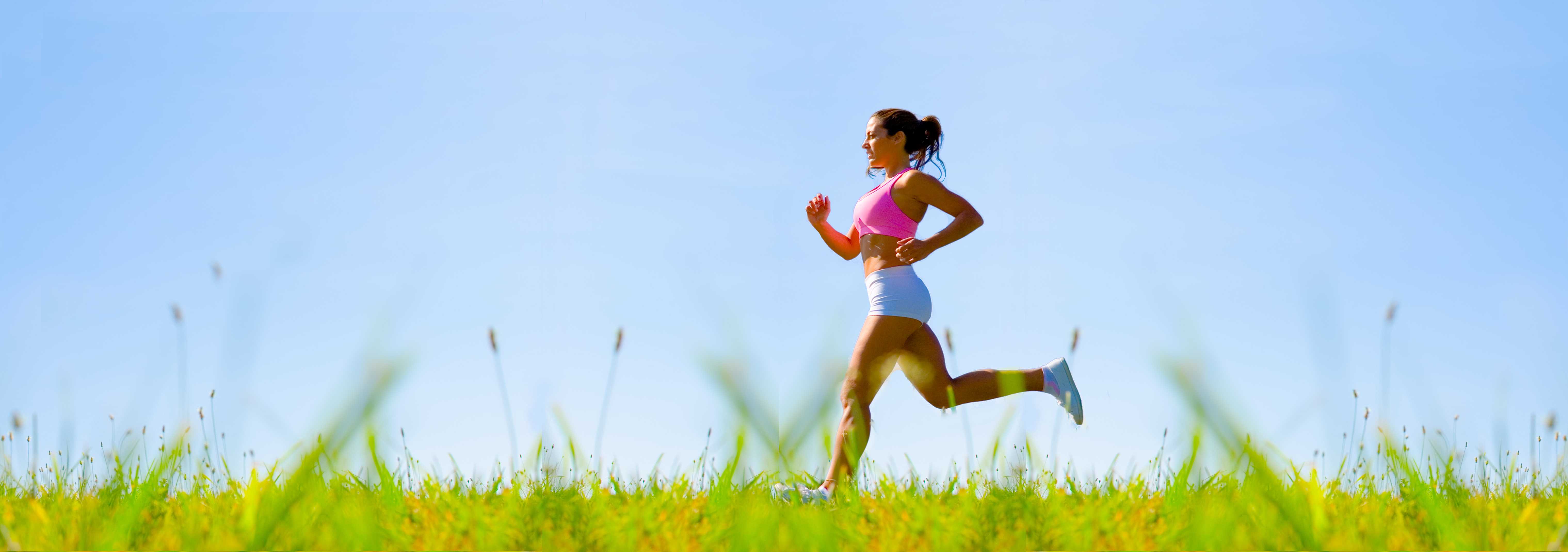 woman jogging across a field